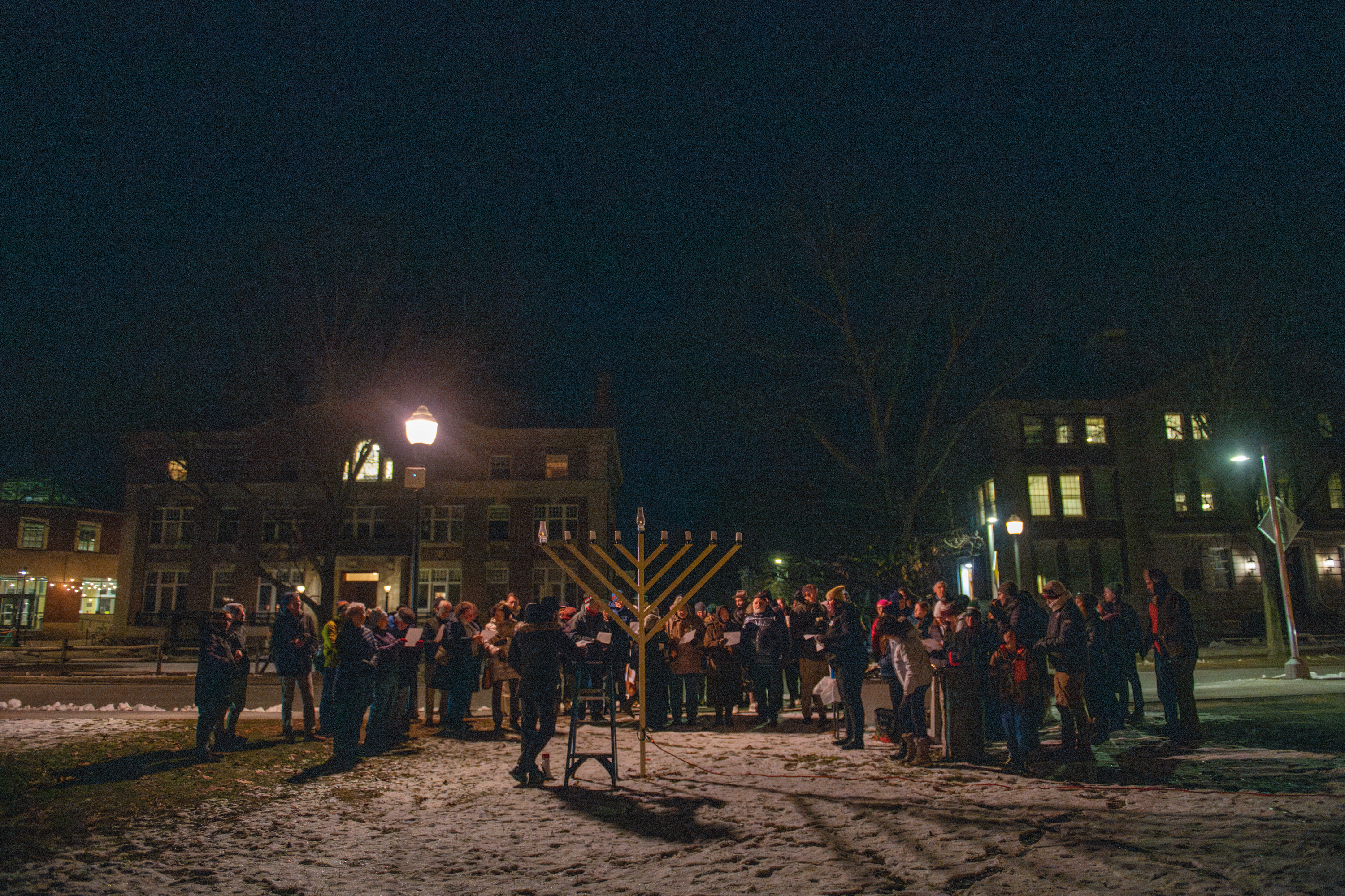 People circled around a Menorah