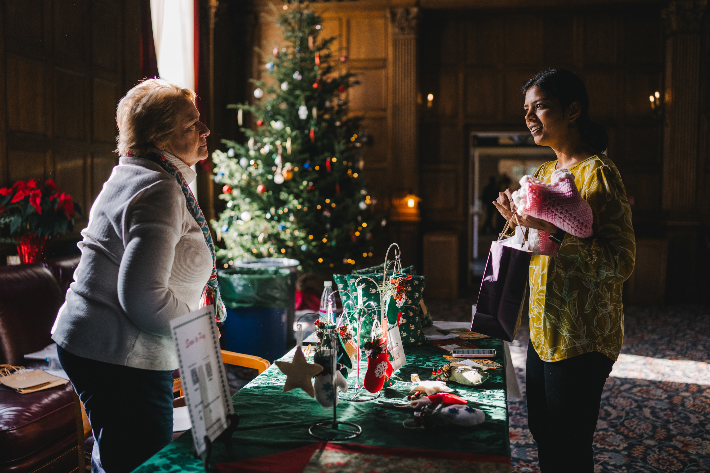 Two women talk at the craft fair
