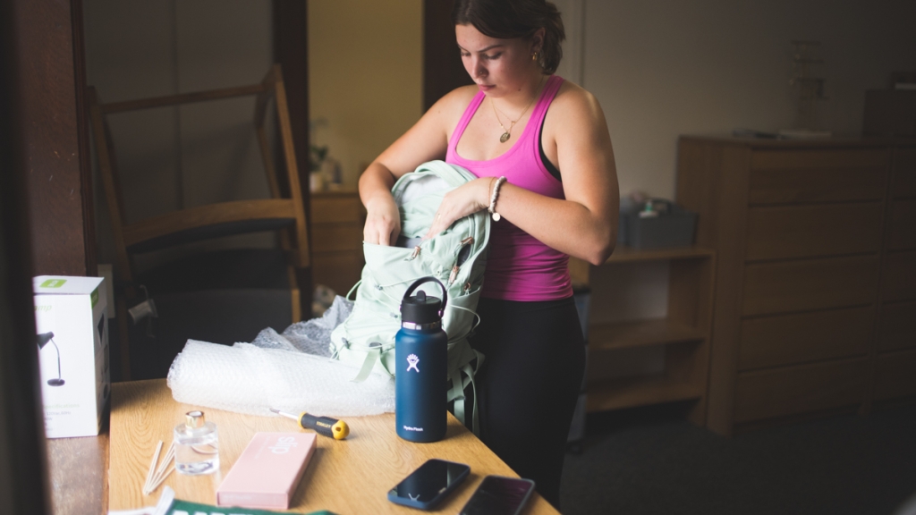 Incoming student unpacks her backpack