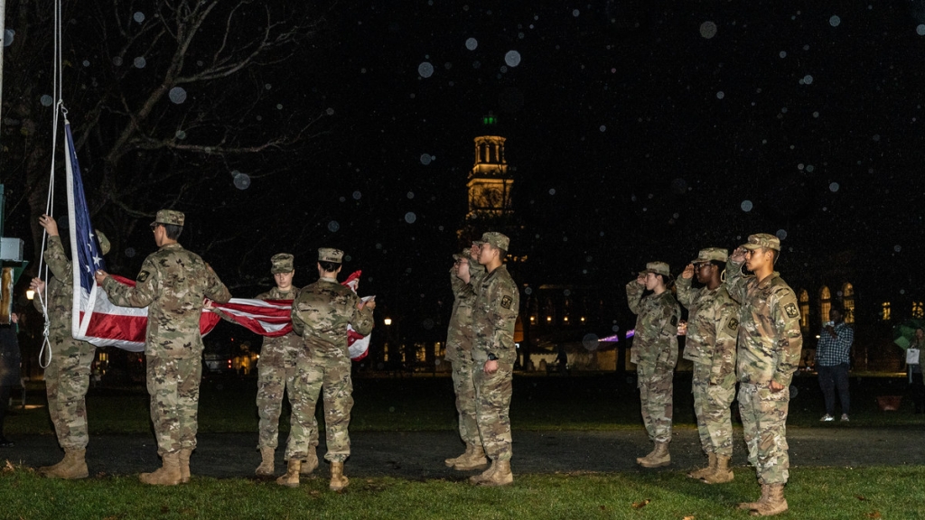 Students in uniform on the Green by the flag