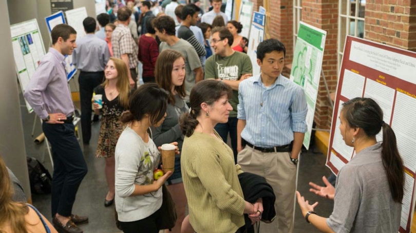 Students gathered for a research poster session.